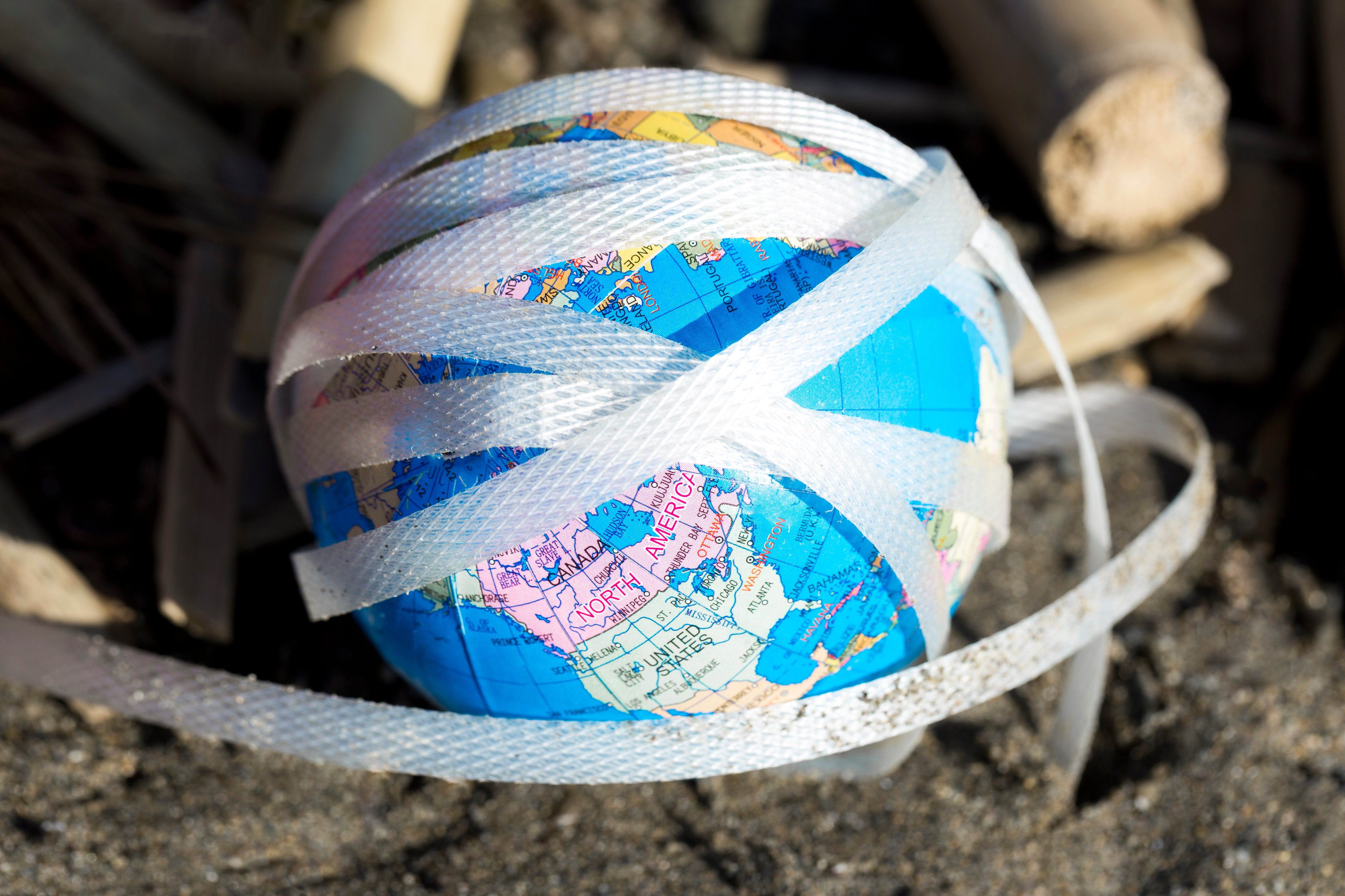 High angle plastic and paper at seaside