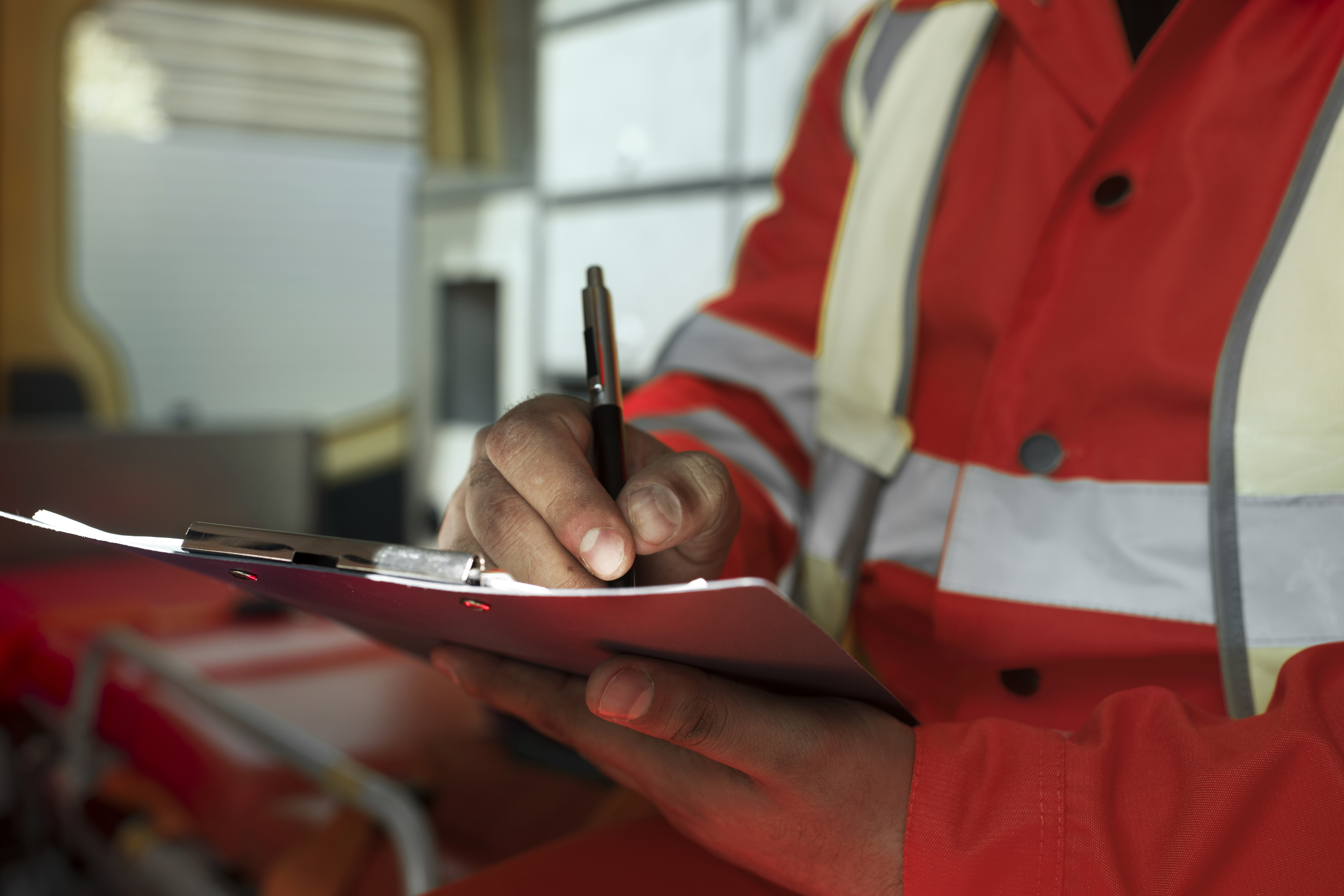 Side view man taking notes in ambulance car